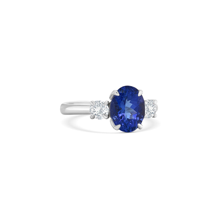 tanzanite trilogy ring, oval tanzanite diamond ring, three-stone tanzanite engagement ring, tanzanite and round diamond ring, elegant tanzanite ring