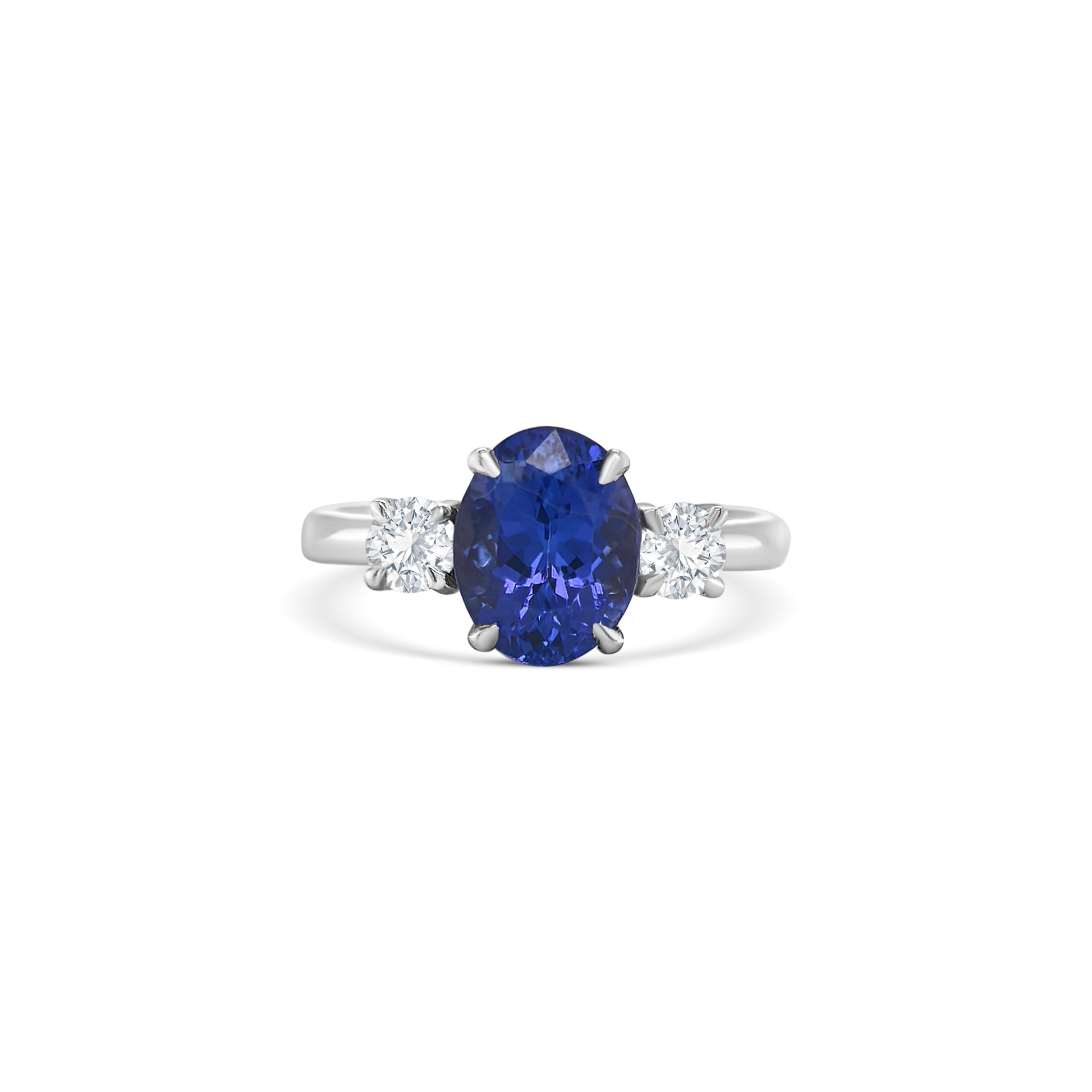 tanzanite trilogy ring, oval tanzanite diamond ring, three-stone tanzanite engagement ring, tanzanite and round diamond ring, elegant tanzanite ring
