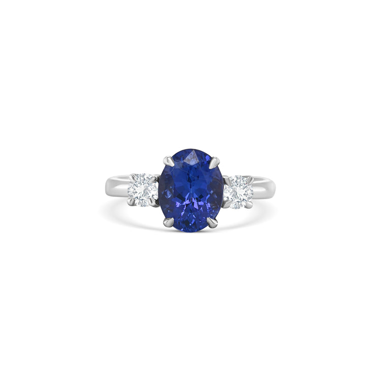 tanzanite trilogy ring, oval tanzanite diamond ring, three-stone tanzanite engagement ring, tanzanite and round diamond ring, elegant tanzanite ring