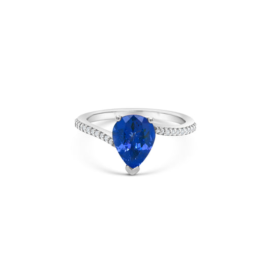 pear shape tanzanite ring, pear cut gemstone ring, tanzanite and diamond ring, elegant pear cut tanzanite jewelry, luxury gemstone ring, women’s tanzanite diamond ring, pear shaped engagement style ring, fine gemstone jewelry, white gold tanzanite and diamond ring, sparkling pear cut tanzanite ring