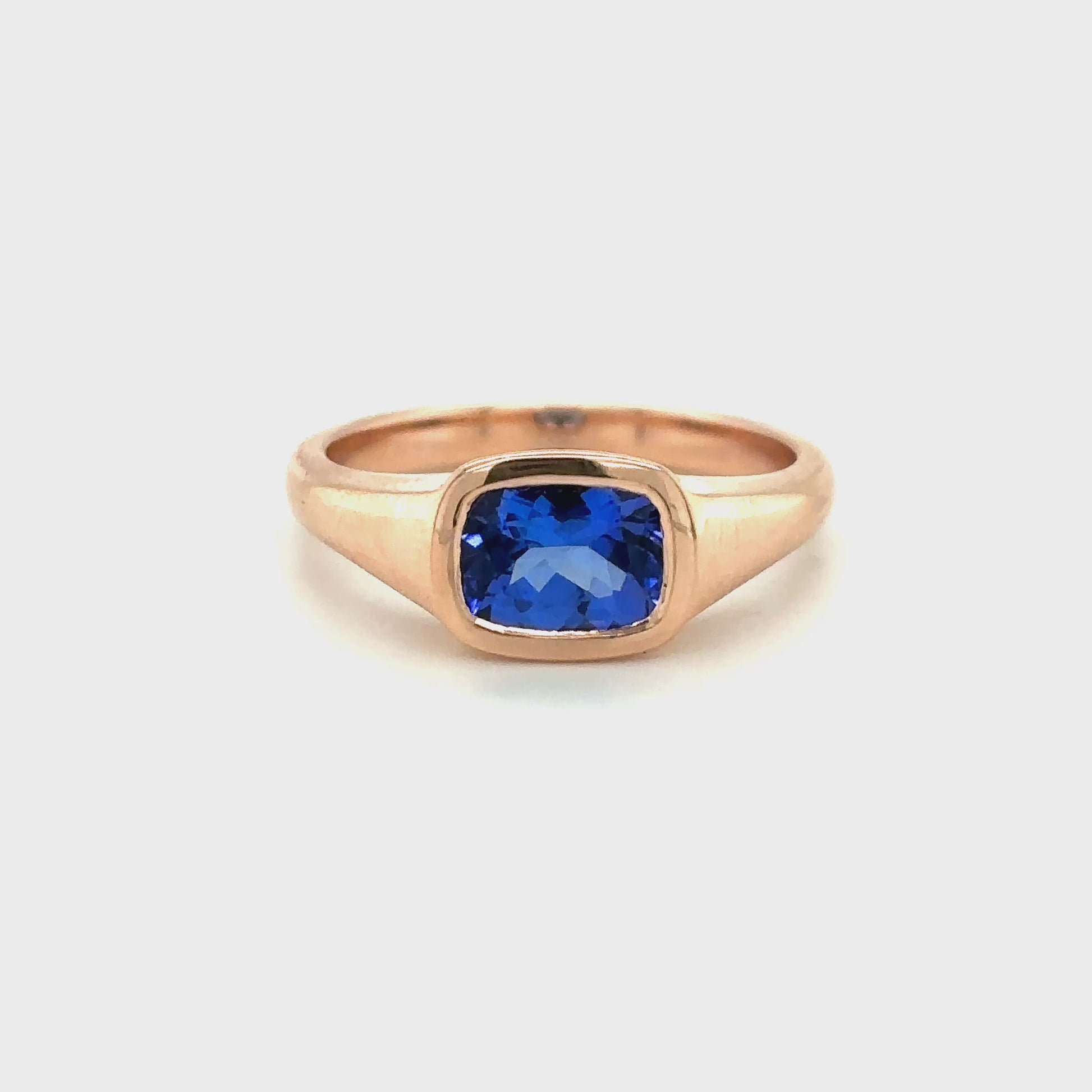 Tube set ring featuring a rectangular cushion-cut tanzanite gemstone in a sleek modern design