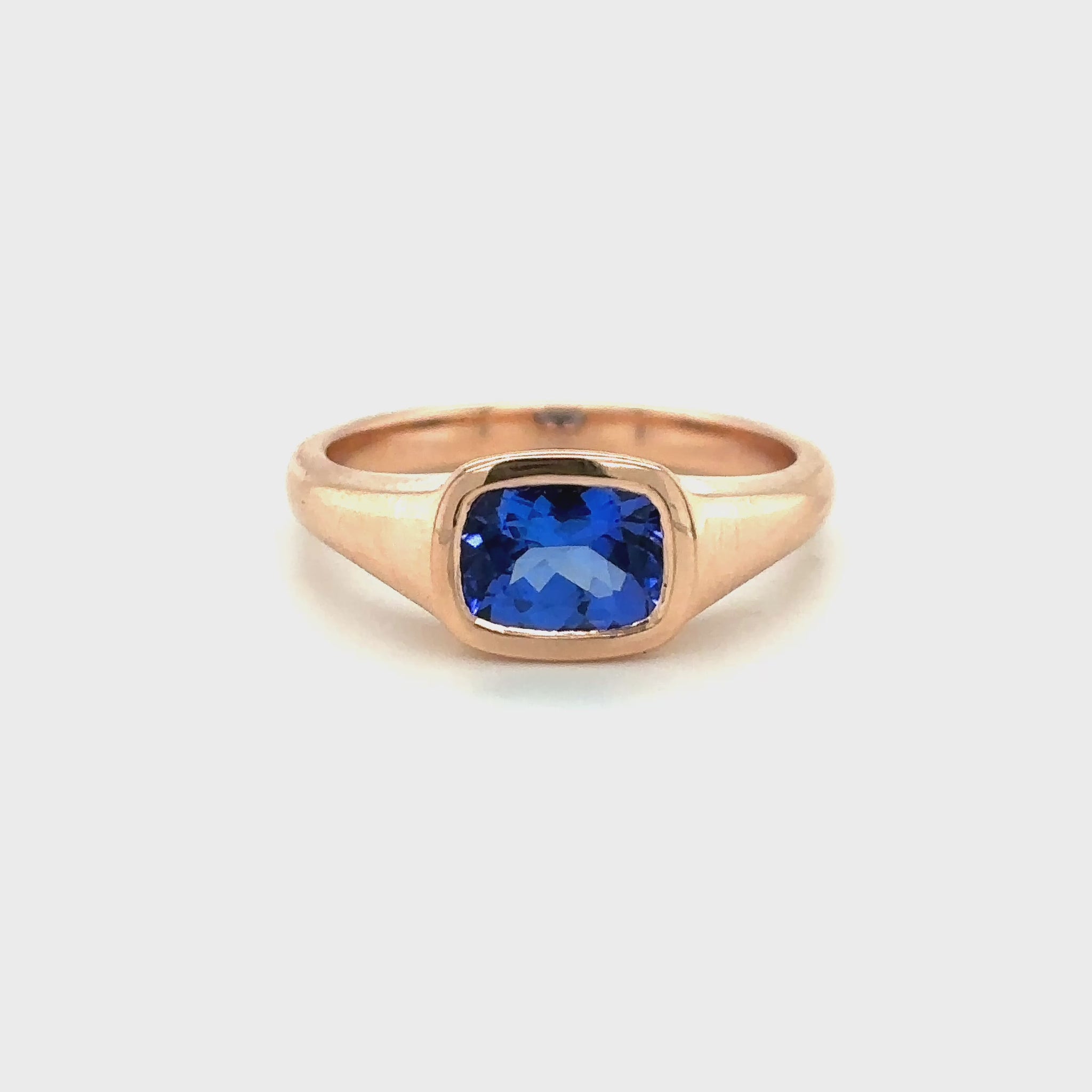 Tube set ring featuring a rectangular cushion-cut tanzanite gemstone in a sleek modern design