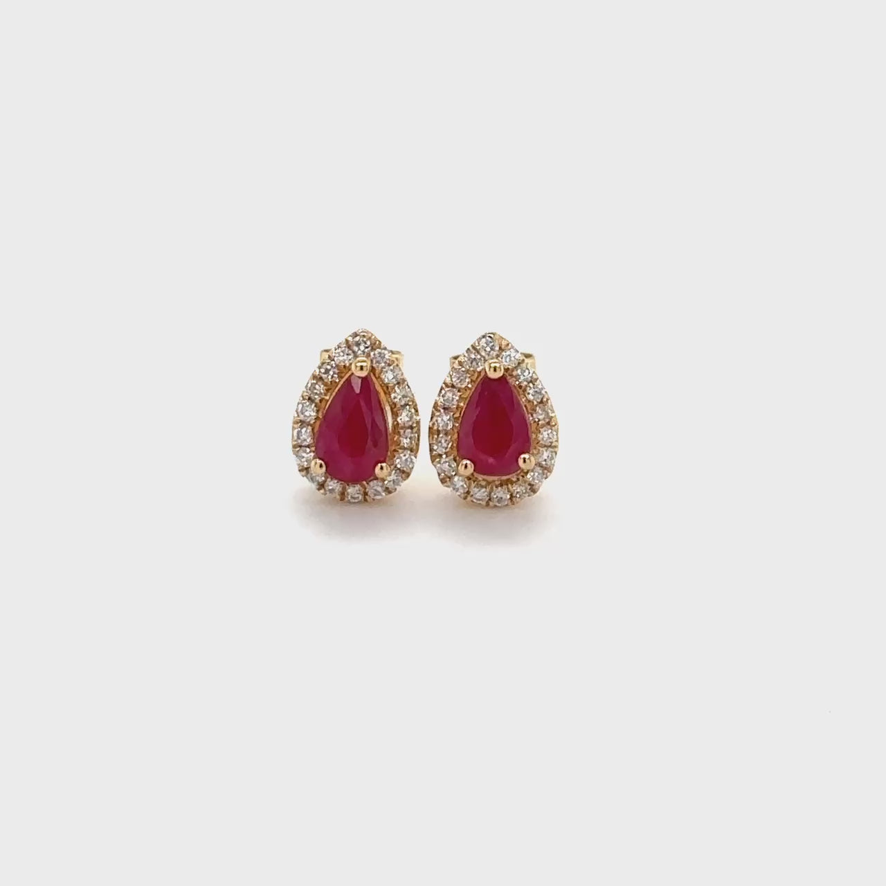"Ruby diamond earrings, Halo stud earrings, Ruby and diamond jewelry, Red gemstone earrings, Sparkling gemstone studs, Elegant jewelry accessories, Precious stone earrings, Glamorous stud earrings, Fine jewelry accents, Luxurious gemstone studs"