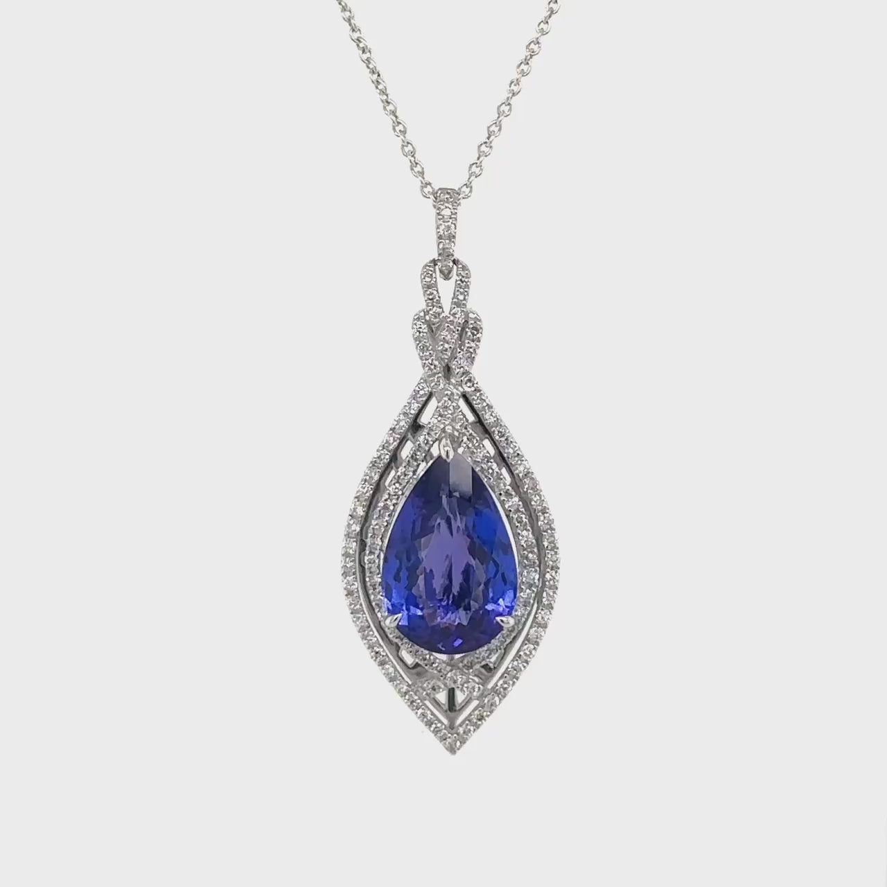 Pear shape tanzanite pendant, elegant tanzanite and diamond jewelry, luxurious gemstone pendant, stunning tanzanite necklace, exquisite pear-cut pendant, sparkling diamond accent pendant, sophisticated gemstone jewelry.