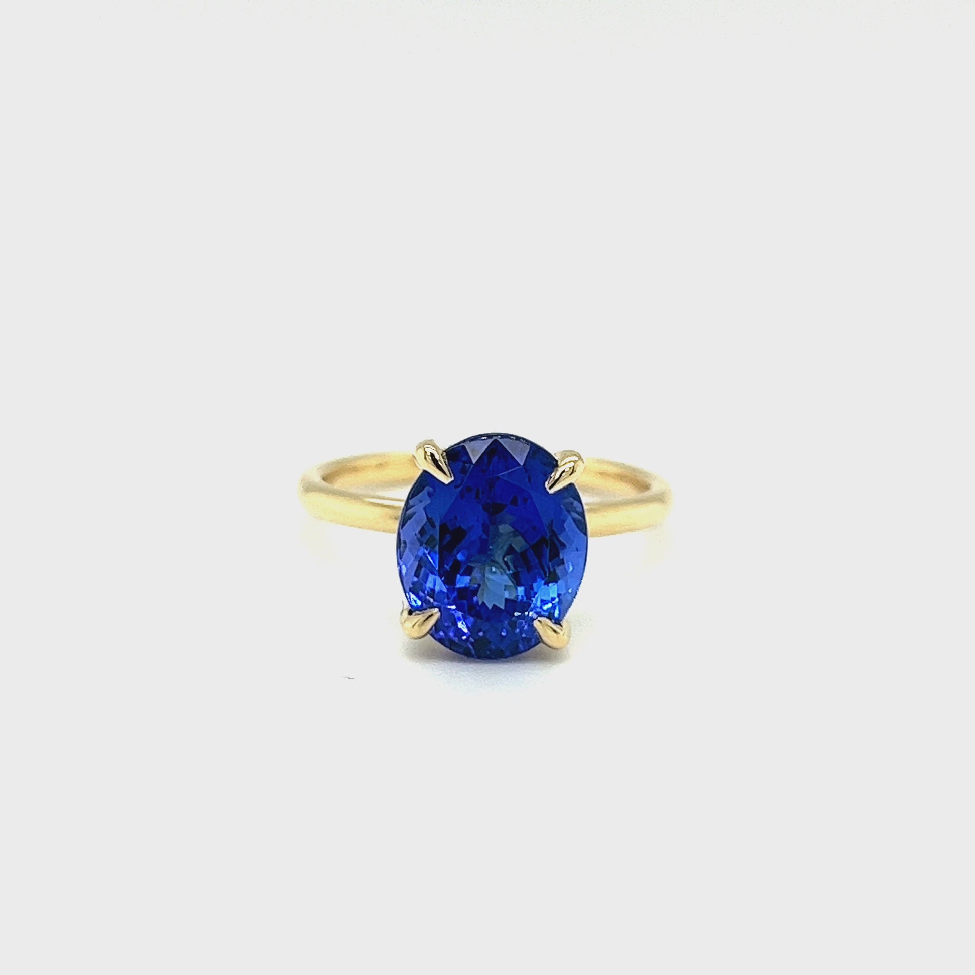 Oval solitaire tanzanite ring 4.10ct tanzanite diamond ring Tanzanite and diamond claw ring Gemstone solitaire jewelry Tanzanite engagement ring Fine jewelry craftsmanship Violet gemstone ring Exquisite diamond accents Luxury gemstone ring Statement solitaire ring Elegance and sophistication Handcrafted claw setting