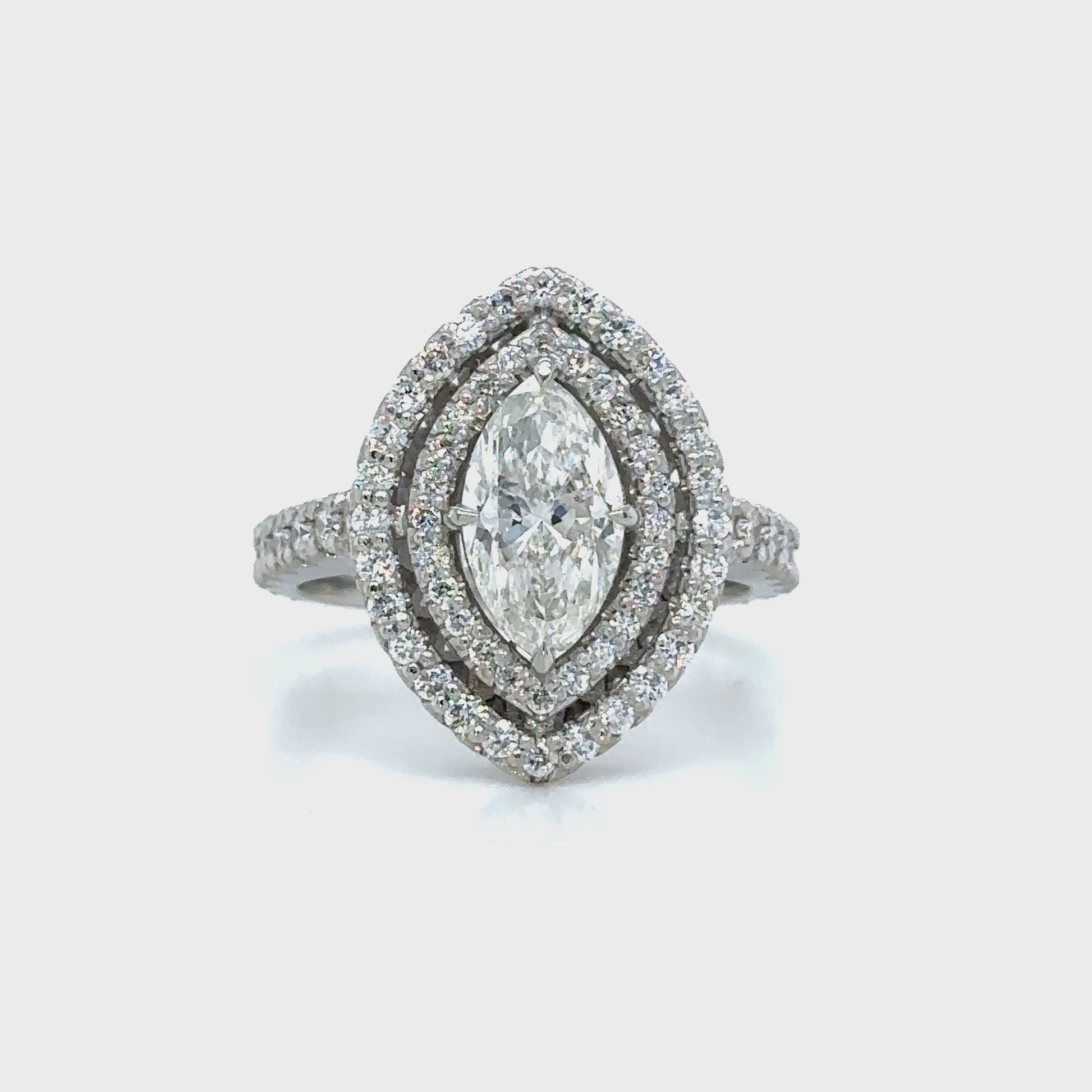 Marquise and round brilliant cut diamond ring with double halo setting, Double halo engagement ring featuring marquise and round brilliant diamonds, Elegant marquise and round diamond ring with sparkling double halo design, Double halo diamond ring showcasing marquise center stone and round accents, Luxury diamond ring with marquise cut center and round brilliant double halo.