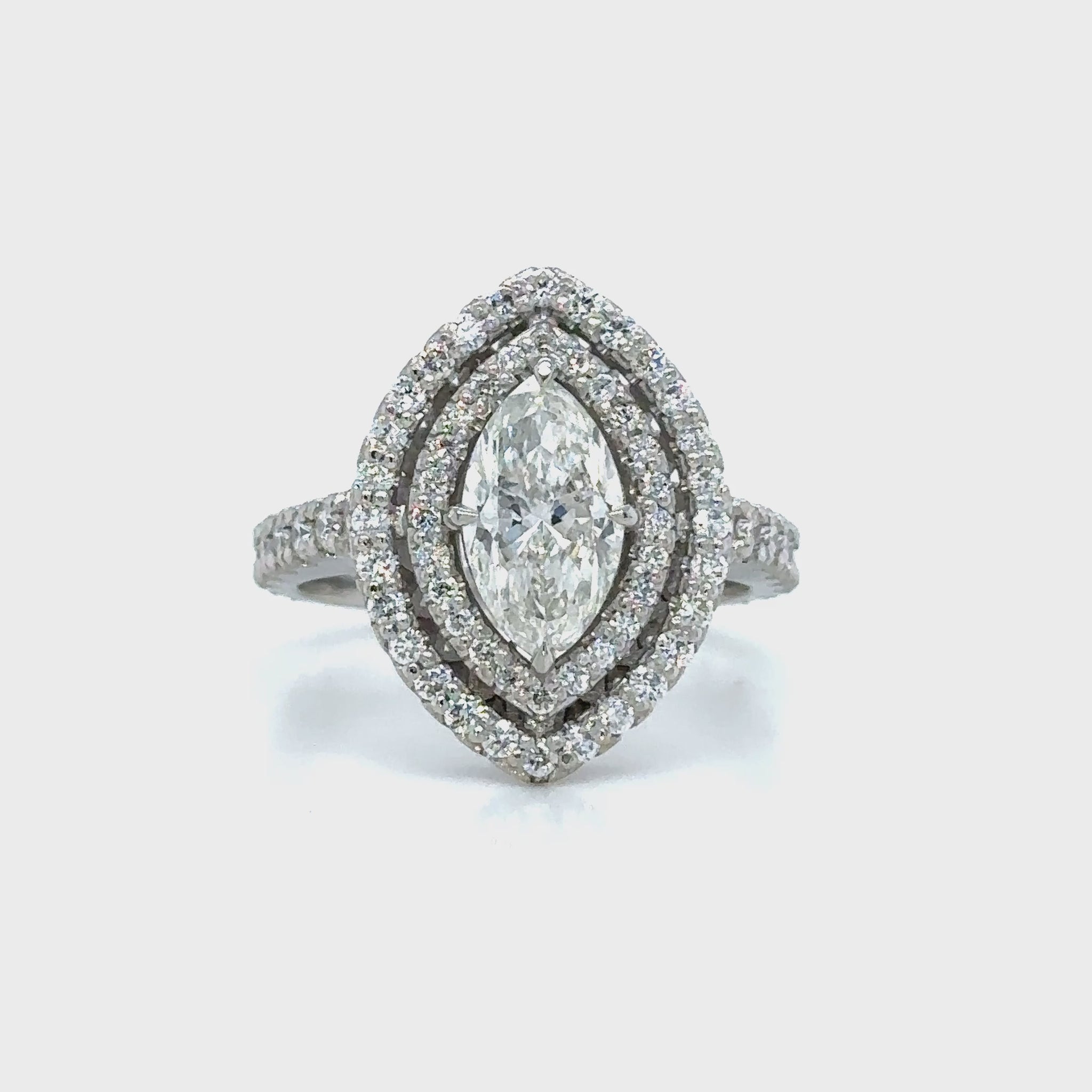 Marquise and round brilliant cut diamond ring with double halo setting, Double halo engagement ring featuring marquise and round brilliant diamonds, Elegant marquise and round diamond ring with sparkling double halo design, Double halo diamond ring showcasing marquise center stone and round accents, Luxury diamond ring with marquise cut center and round brilliant double halo.