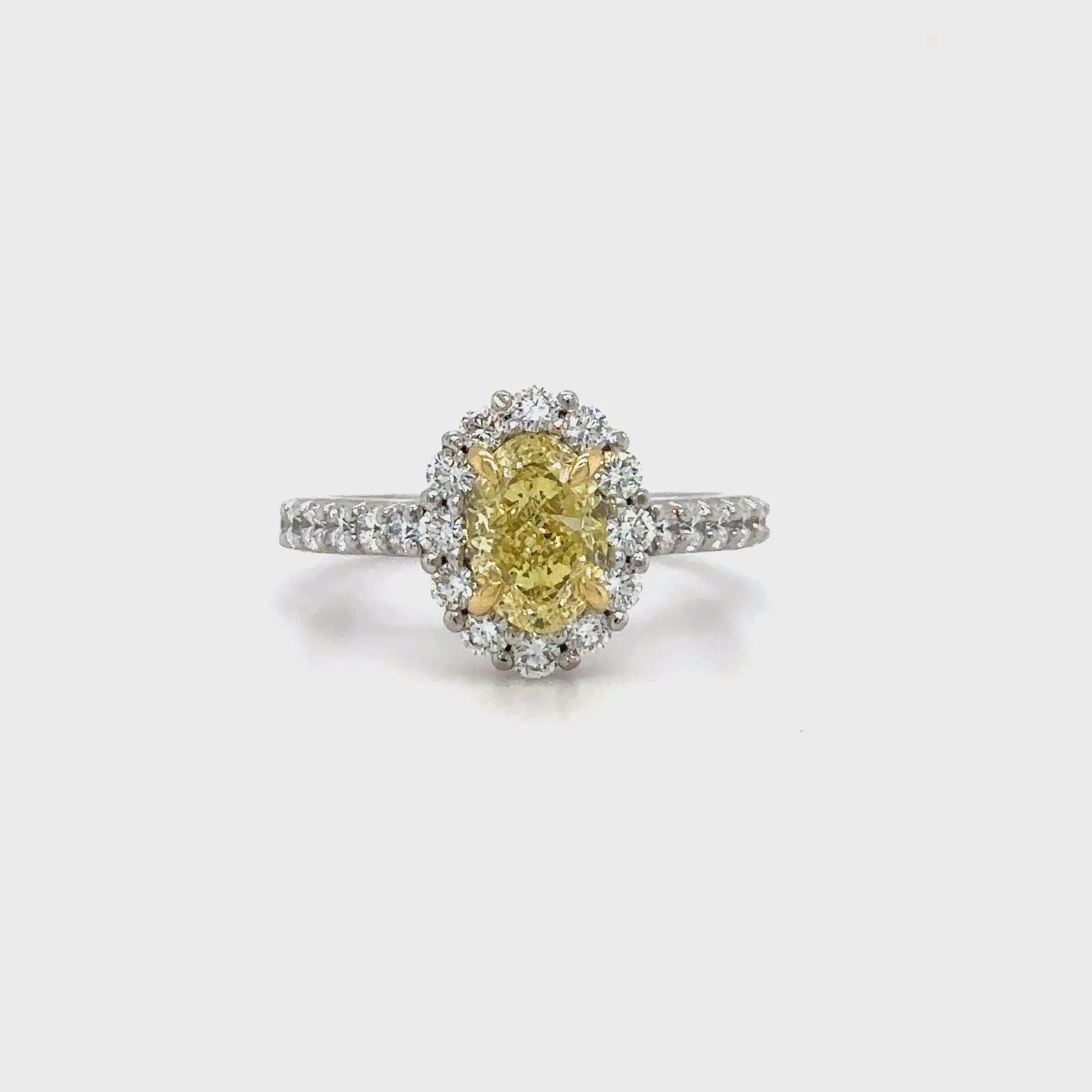 Discover timeless elegance with this Fancy Yellow Oval and Floral Diamond Halo Ring. A stunning blend of luxury and craftsmanship, perfect for any special occasion