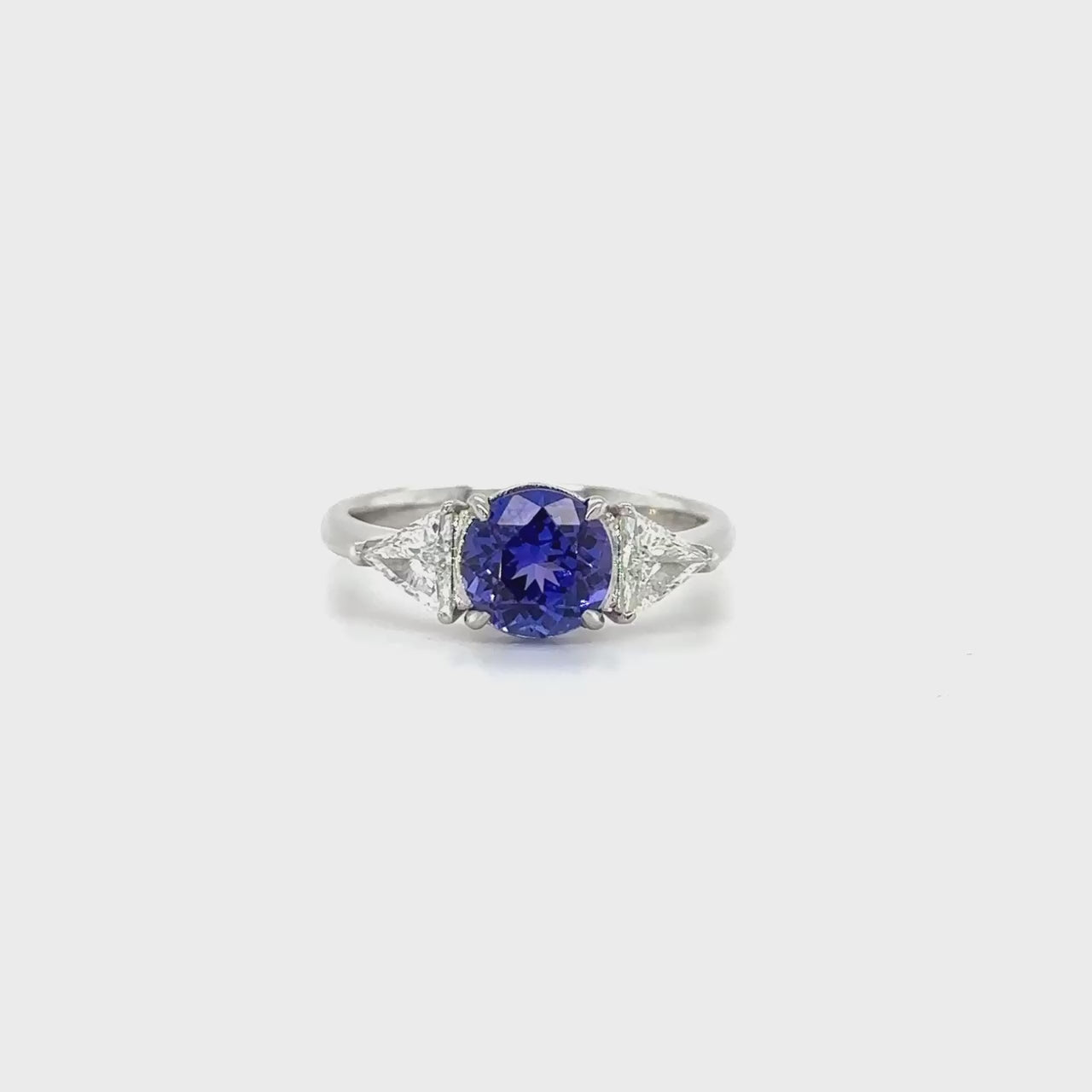 "Round Cut Tanzanite & Diamond Ring," "Exquisite Round Cut Tanzanite Ring," "Luxurious Diamond Jewelry with Round Cut Tanzanite," "Elegant Round Cut Gemstone Ring," "Fine Jewelry featuring Round Cut Tanzanite and Diamonds," "High-Quality Round Cut Tanzanite Ring," "Statement Round Cut Gemstone and Diamond Ring," "Sparkling Tanzanite and Diamond Jewelry with Round Cut," "Beautiful Round Cut Gemstone Ring," "Fashionable Tanzanite & Diamond Ring with Round Cut."