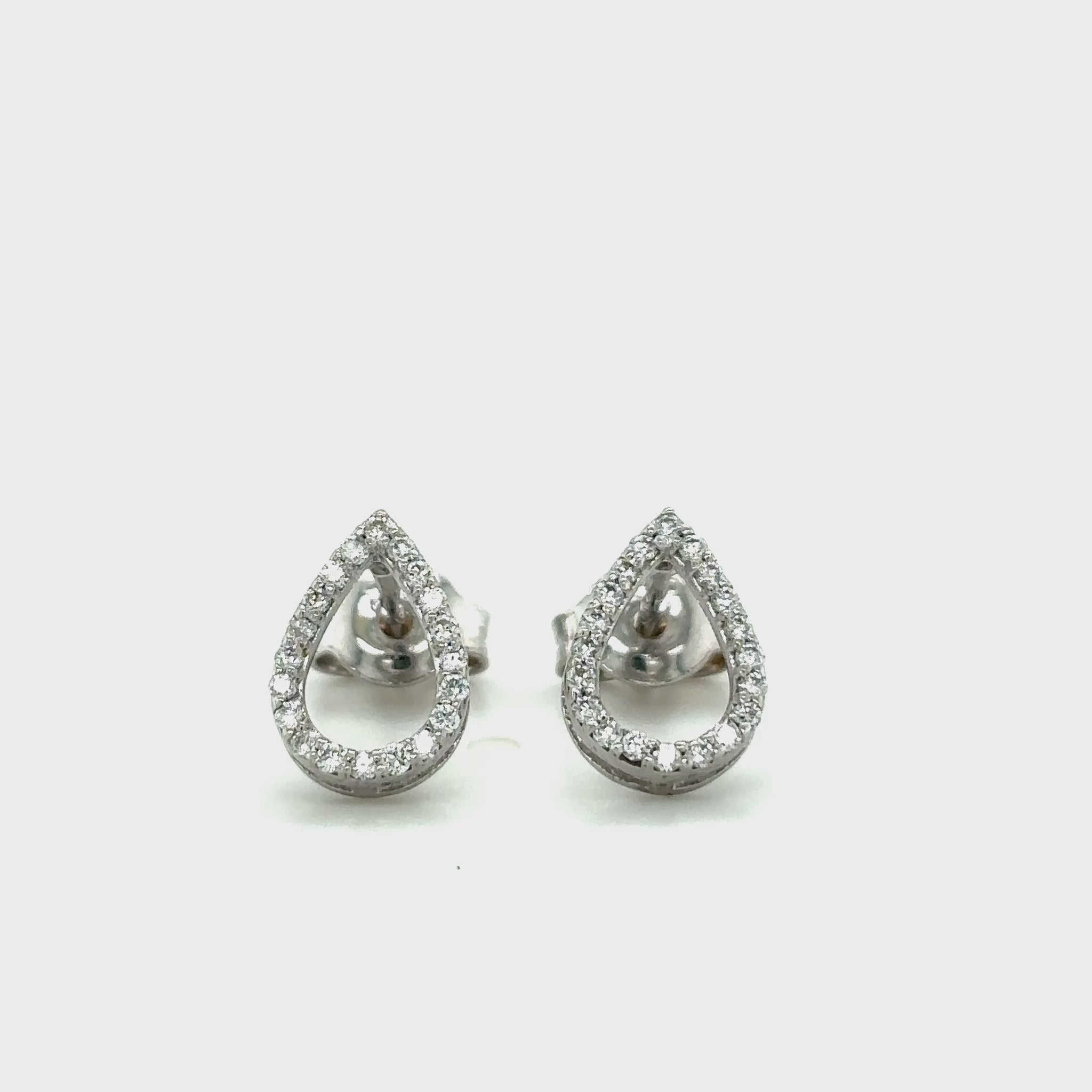Elegant tear drop halo diamond stud earrings in white gold with sparkling round accent diamonds.