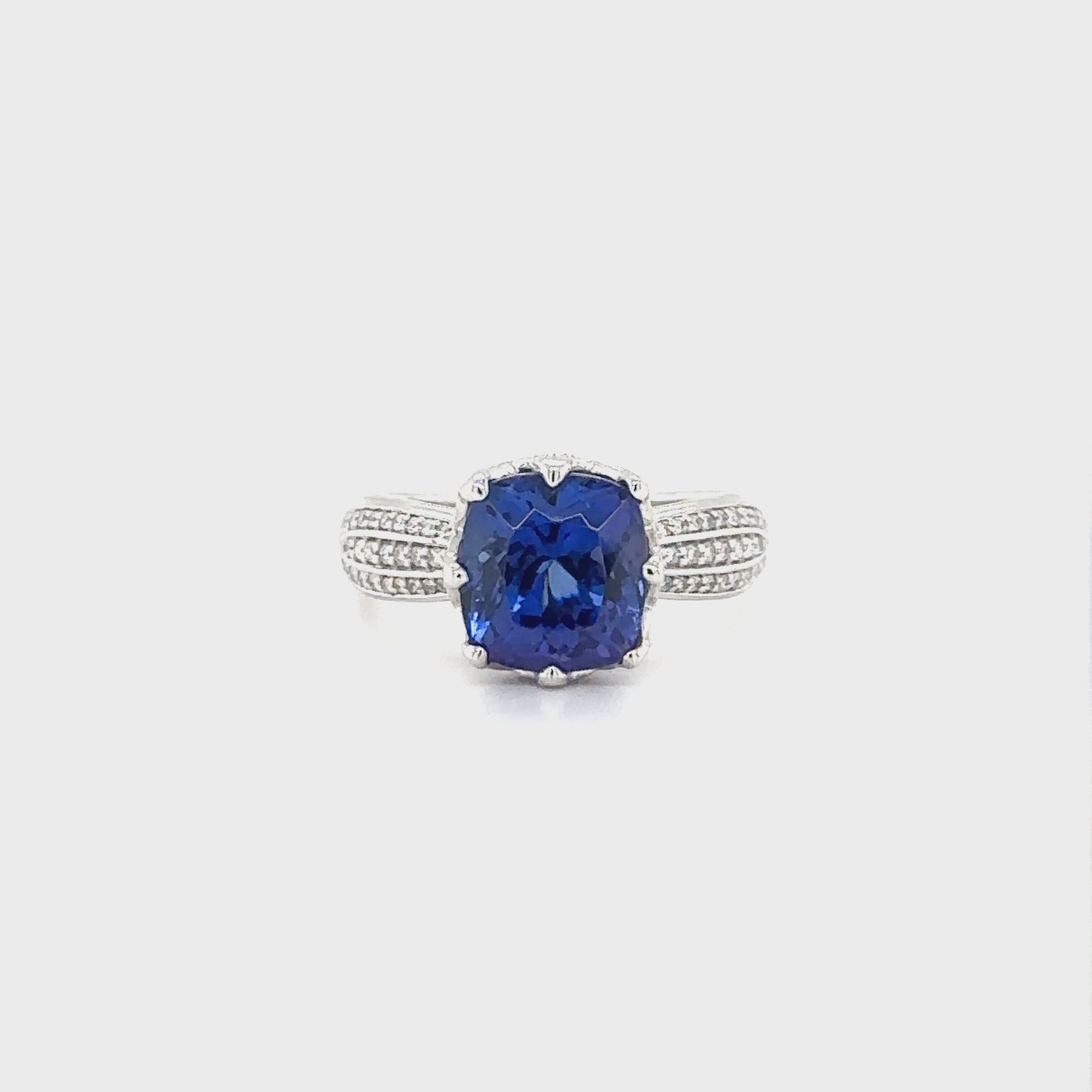 "Cushion Cut Tanzanite & Diamond Ring," "Exquisite Cushion Cut Tanzanite Ring," "Luxurious Diamond Ring with Cushion Cut Tanzanite," "Elegant Cushion Cut Gemstone Ring," "Fine Jewelry with Cushion Cut Tanzanite and Diamonds," "High-Quality Diamond Ring with Cushion Cut Tanzanite," "Statement Cushion Cut Tanzanite and Diamond Ring," "Sparkling Tanzanite and Diamond Ring," "Beautiful Cushion Cut Gemstone Ring," "Fashionable Tanzanite & Diamond Ring."