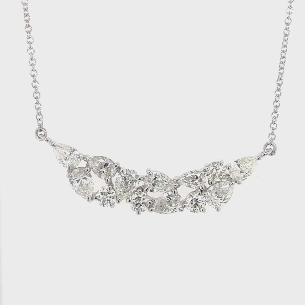 A stunning Round Brilliant & Pear Shaped Diamond Pendant, sparkling brilliance, elegant design, timeless beauty, luxurious jewelry, exquisite craftsmanship