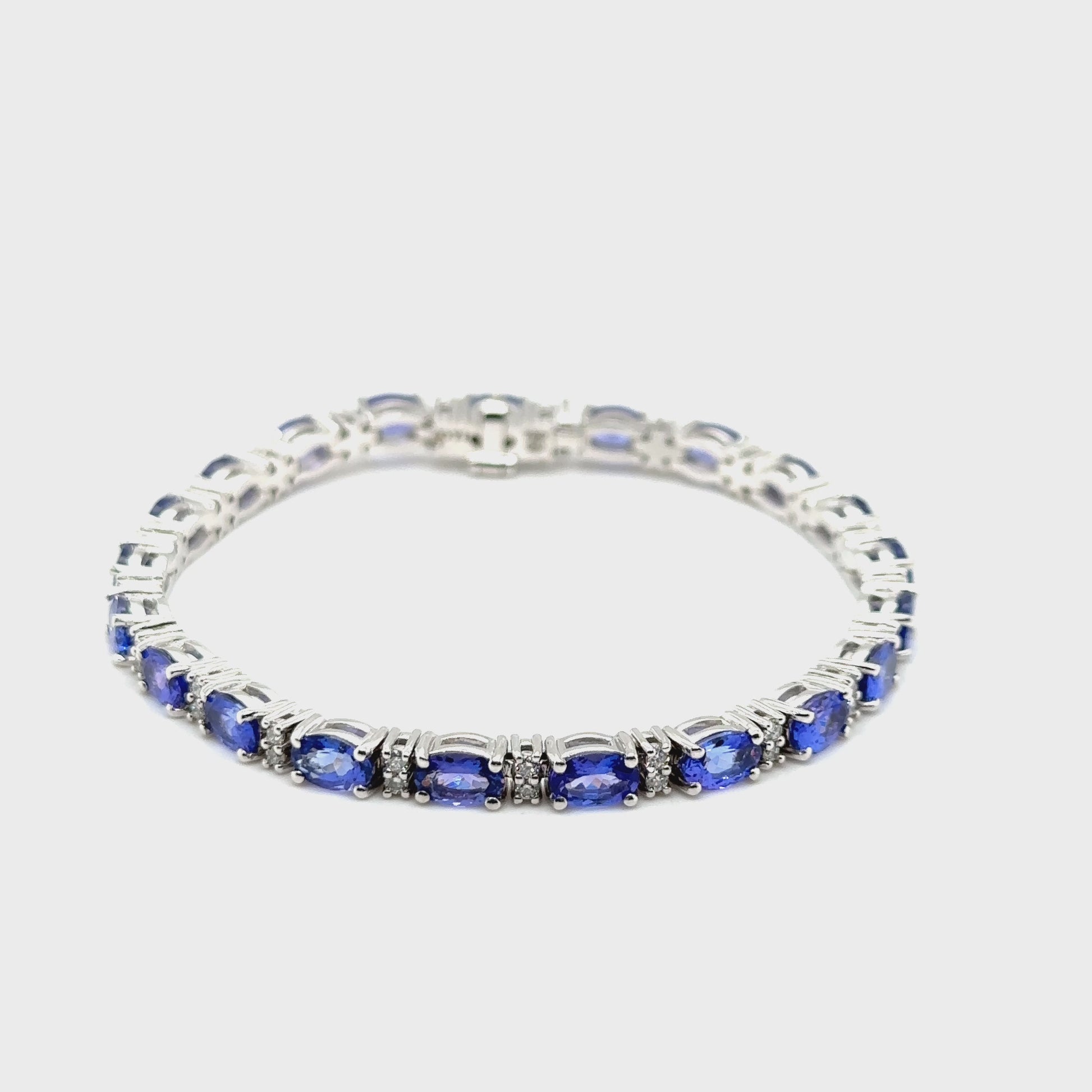 "Oval Tanzanite Bracelet, Tanzanite and Diamond Jewelry, Gemstone Diamond Bracelet, Fine Jewelry Bracelet, Elegant Gemstone Bracelet, Tanzanite and Diamond Accent Bracelet, Oval Tanzanite and Diamond Wristwear, Luxury Gemstone Jewelry, Oval Tanzanite with Diamond Accents, Stylish Gemstone Bracelet"