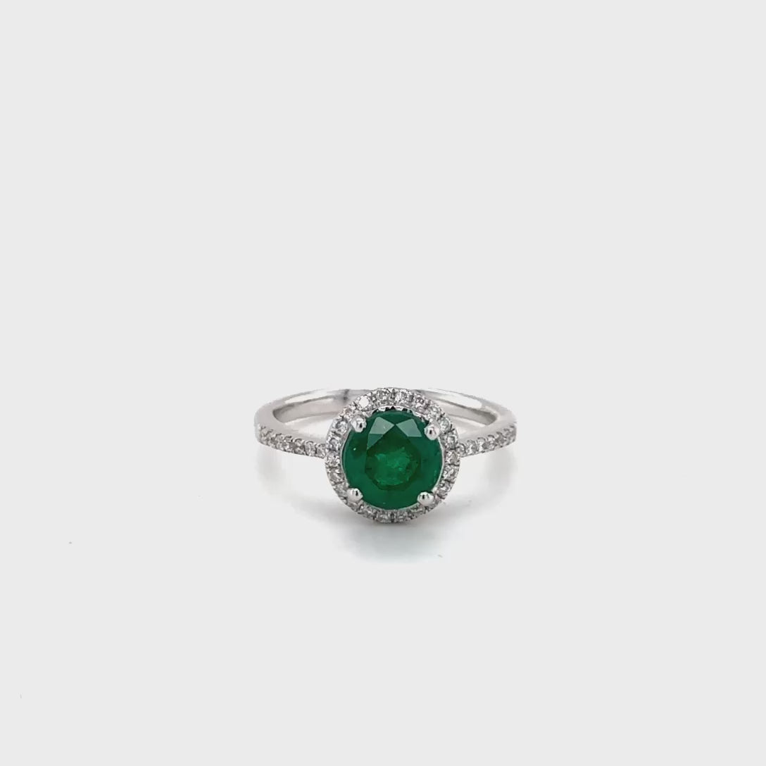 Round emerald diamond halo ring, green gemstone engagement band, elegant emerald jewelry, sparkling diamond accents, luxurious halo setting, fine jewelry gift for her.