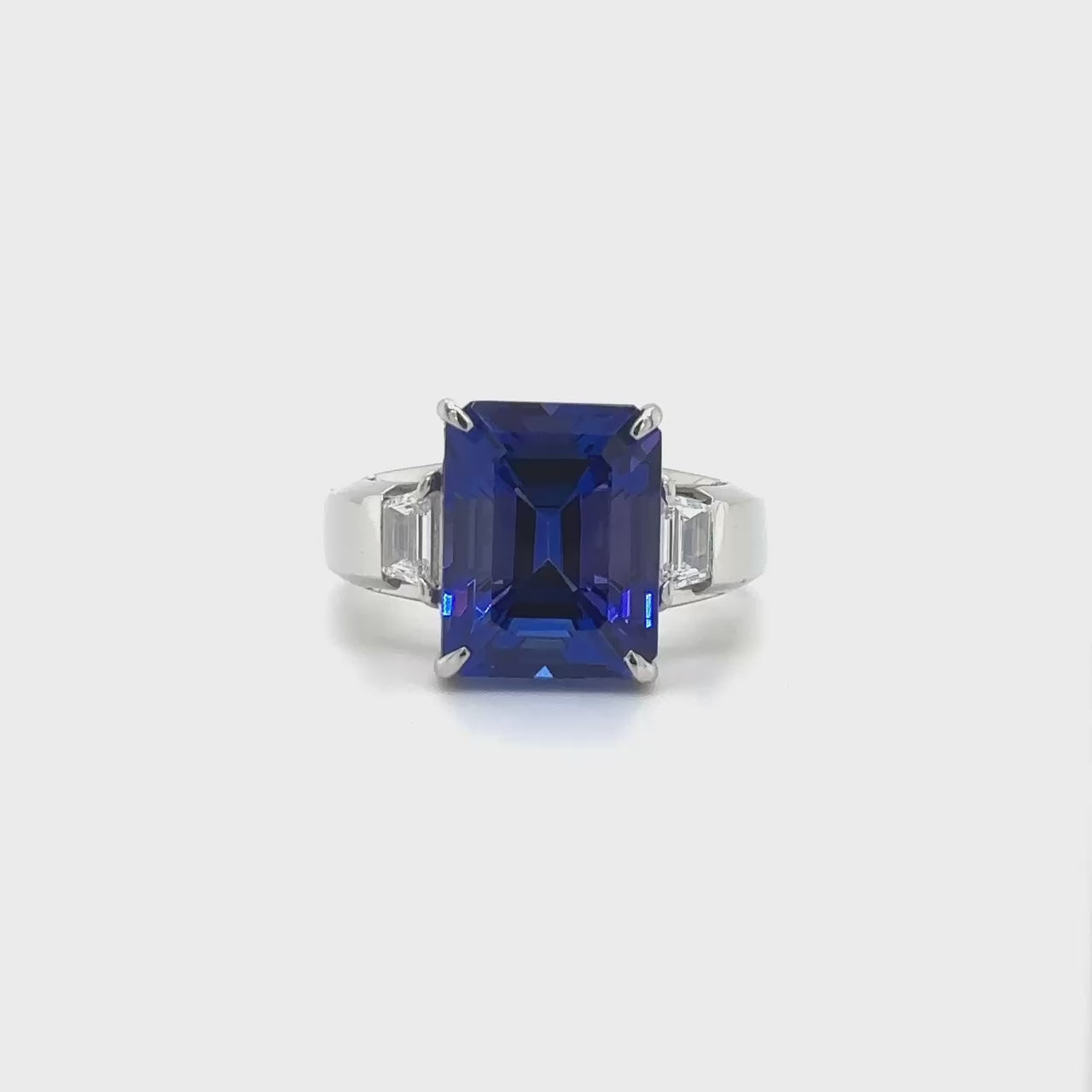 Emerald cut tanzanite ring, Trilogy ring, Diamond accent ring, Elegant gemstone jewelry, Statement piece, Luxury fashion accessory.