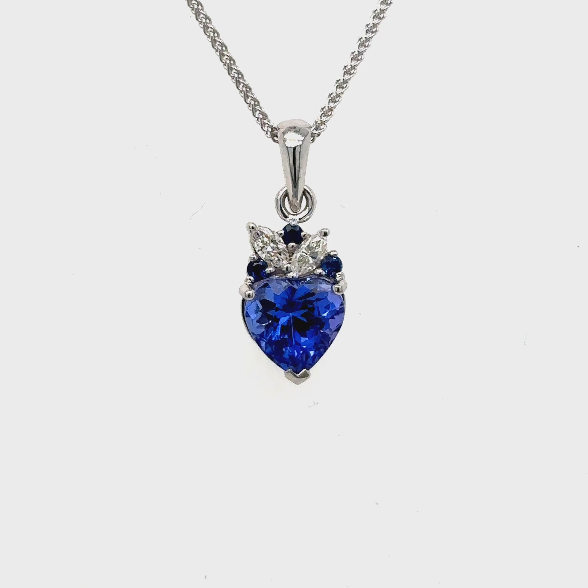 Make a statement with our heart-shaped tanzanite gemstone pendant, framed by dazzling sapphires and marquise diamonds.