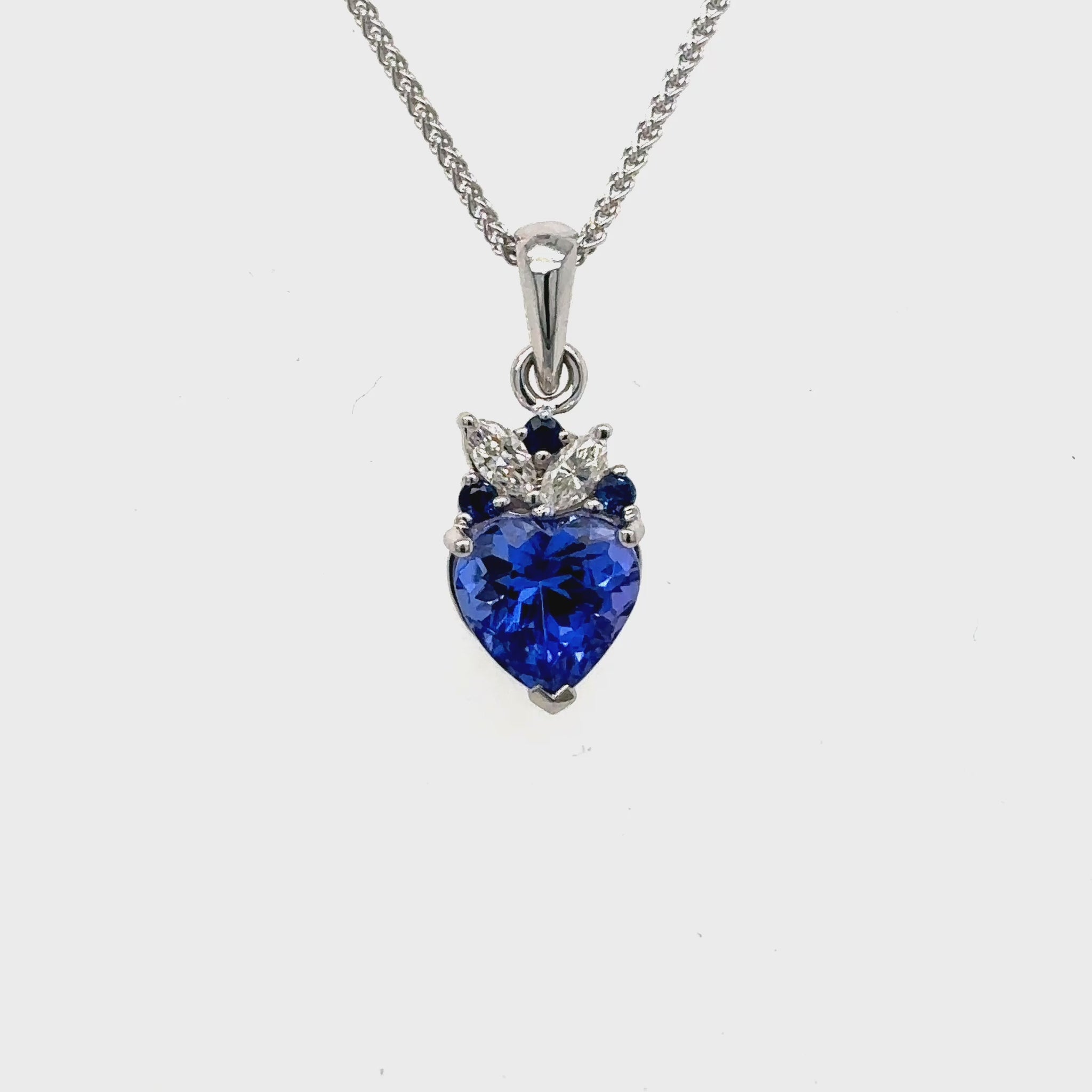 Make a statement with our heart-shaped tanzanite gemstone pendant, framed by dazzling sapphires and marquise diamonds.