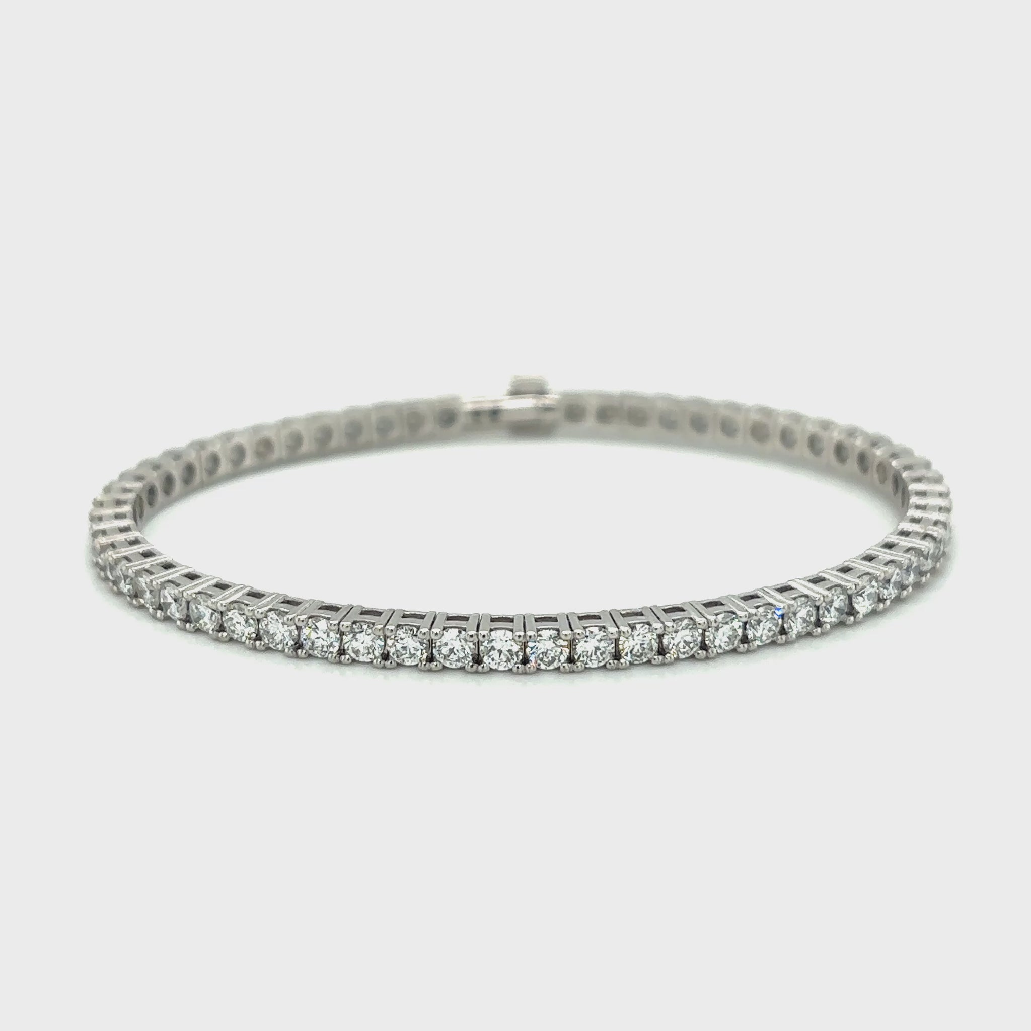 Diamond tennis bracelet with a row of round-cut diamonds set in white gold.