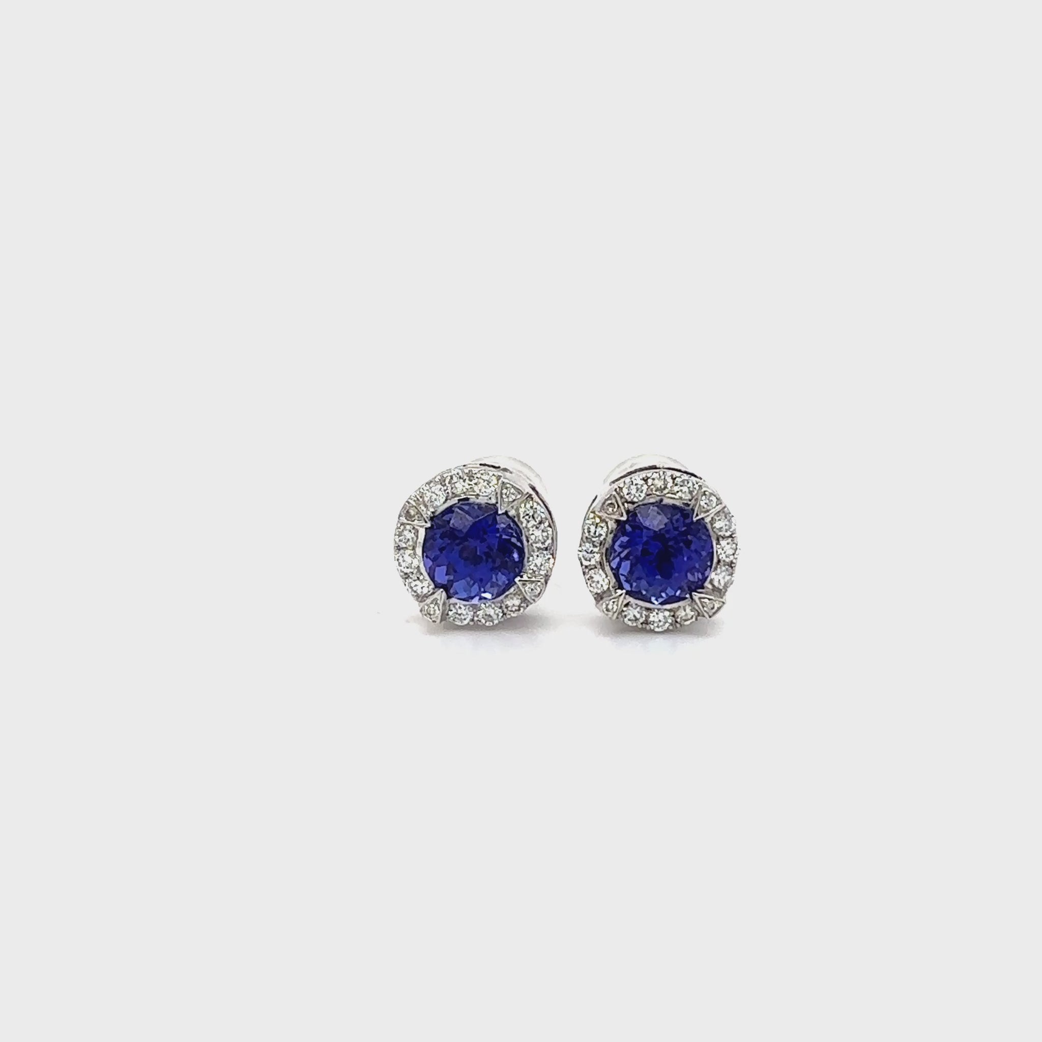 Round Tanzanite & Diamond Halo Stud Earrings" Tanzanite Detail: "Vibrant Round Tanzanite Gemstone" Diamond Halo: "Halo of Diamonds Surrounding Tanzanite" Earring Set: "Elegant Set of Tanzanite & Diamond Stud Earrings" Liner Options: "Earrings with Different Open Liners for Customization" Radiant Beauty: "Sparkling Tanzanite & Diamond Halo Stud Earrings"